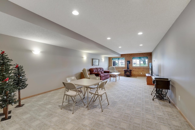 10777 181st Cir NW, Elk River, MN 55330 - dining area with light carpet, a wood stove, recessed lighting, and wooden walls
