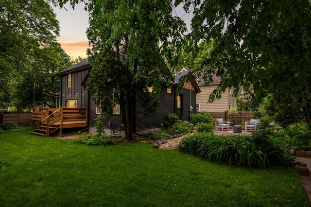 2916 26th St, Minneapolis, MN 55406 - rear view of house featuring a wooden deck, board and batten siding, and a patio