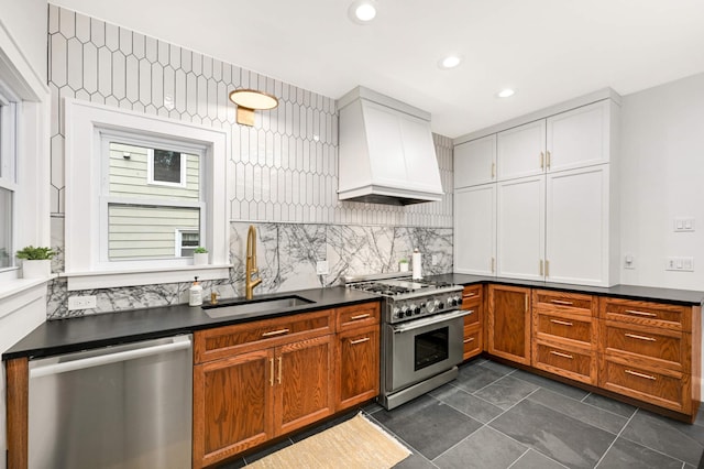 2916 26th St, Minneapolis, MN 55406 - kitchen with stainless steel appliances, custom range hood, a sink, dark countertops, and recessed lighting