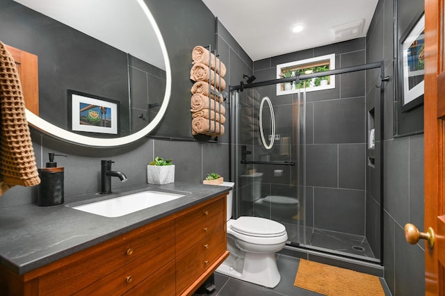 2916 26th St, Minneapolis, MN 55406 - bathroom featuring toilet, vanity, a stall shower, and tile patterned floors