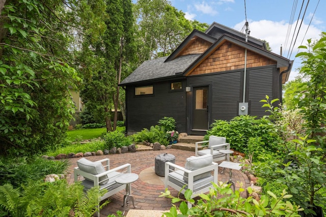 2916 26th St, Minneapolis, MN 55406 - rear view of house featuring roof with shingles and a patio area