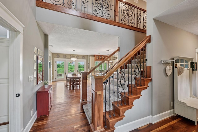 1755 Chateau Way, Minnetrista, MN 55359 - stairway featuring wood finished floors and a textured ceiling