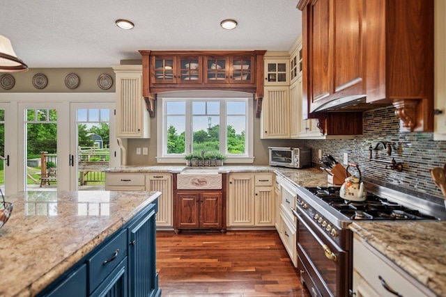 1755 Chateau Way, Minnetrista, MN 55359 - kitchen with stainless steel range, blue cabinets, dark wood-style flooring, decorative backsplash, and light stone countertops