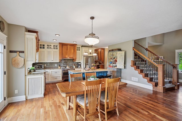 1755 Chateau Way, Minnetrista, MN 55359 - dining room featuring hardwood / wood-style floors, stairway, and recessed lighting