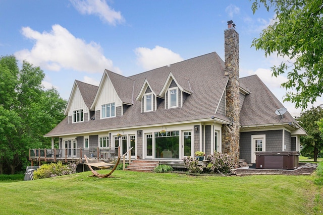 1755 Chateau Way, Minnetrista, MN 55359 - back of property with a hot tub, a chimney, a wooden deck, a yard, and a shingled roof