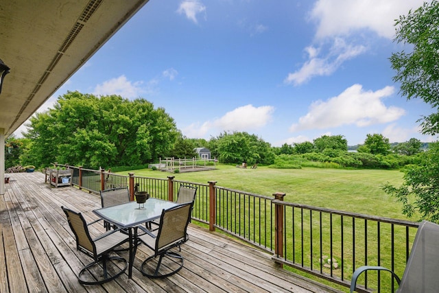 1755 Chateau Way, Minnetrista, MN 55359 - wooden deck with outdoor dining space, a yard, and view of wooded area
