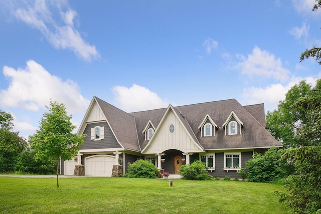 1755 Chateau Way, Minnetrista, MN 55359 - view of front of home featuring an attached garage, a front yard, and board and batten siding