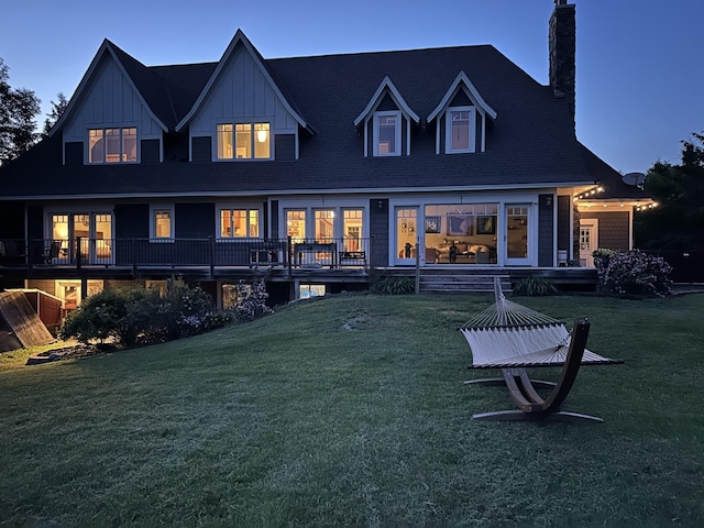 1755 Chateau Way, Minnetrista, MN 55359 - back of house with a chimney, a lawn, and board and batten siding