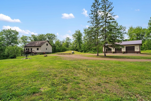 43190 Government Rd, Hinckley, MN 55037 - view of grassy yard with dirt driveway, an attached garage, and a wooden deck