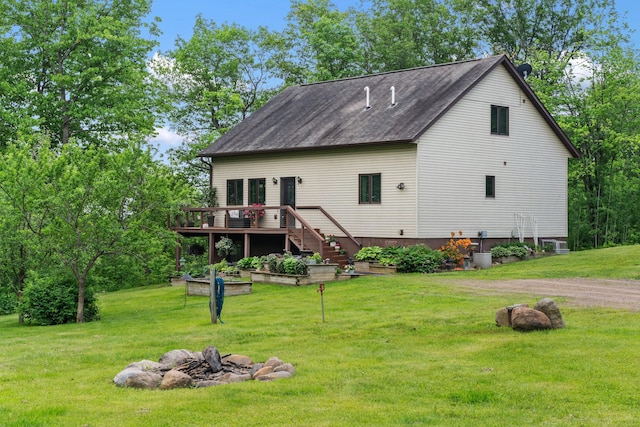 43190 Government Rd, Hinckley, MN 55037 - rear view of property with a wooden deck, a fire pit, stairway, and a yard