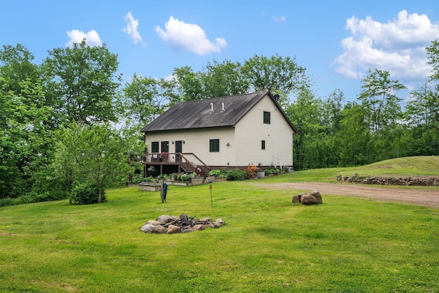 43190 Government Rd, Hinckley, MN 55037 - view of side of property featuring a fire pit, a wooden deck, a yard, and driveway
