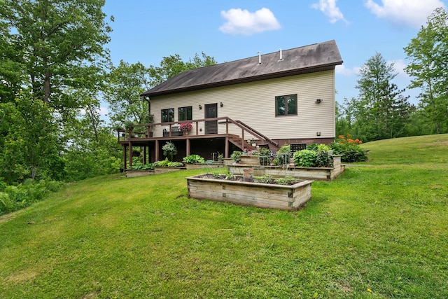 43190 Government Rd, Hinckley, MN 55037 - rear view of property with a vegetable garden, a wooden deck, and a lawn