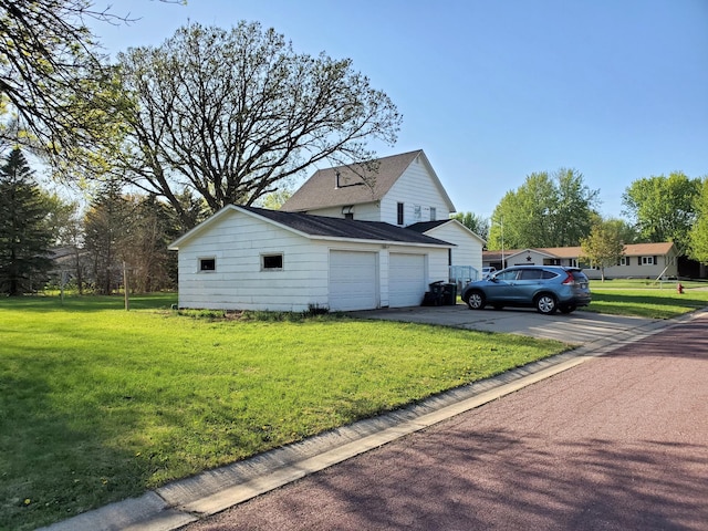 801 Greenwood Ave, Tracy, MN 56175 - view of side of home featuring a garage, a lawn, and a shingled roof