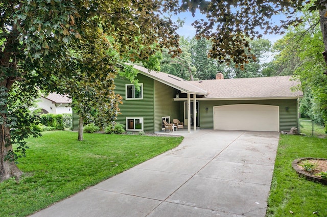 8409 Knollwood Dr, Mounds View, MN 55112 - view of front of house with an attached garage, a chimney, a front yard, and concrete driveway