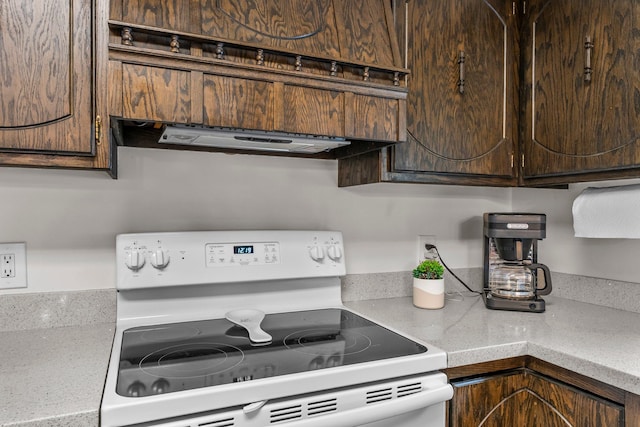 8409 Knollwood Dr, Mounds View, MN 55112 - kitchen with white range with electric cooktop, range hood, dark brown cabinets, and light countertops