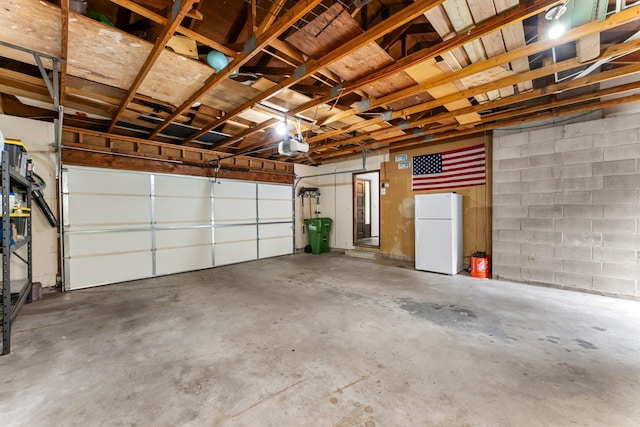 8409 Knollwood Dr, Mounds View, MN 55112 - garage featuring freestanding refrigerator, a garage door opener, and concrete block wall