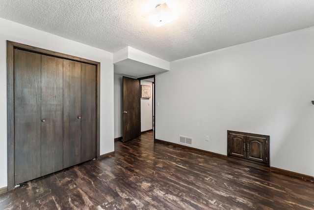 8409 Knollwood Dr, Mounds View, MN 55112 - unfurnished bedroom with wood finished floors, a closet, baseboards, and a textured ceiling