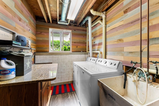 8409 Knollwood Dr, Mounds View, MN 55112 - laundry room with washer and clothes dryer, cabinet space, wooden walls, and wood finished floors