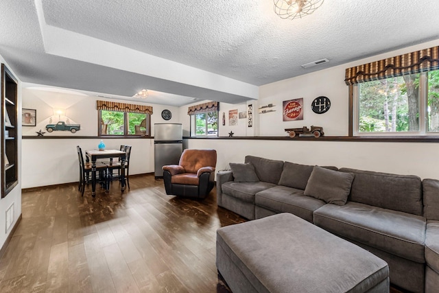 8409 Knollwood Dr, Mounds View, MN 55112 - living room with wood finished floors, a textured ceiling, and baseboards