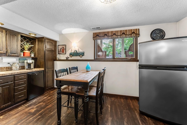 8409 Knollwood Dr, Mounds View, MN 55112 - dining room featuring bar with sink, dark wood-style flooring, a textured ceiling, and baseboards