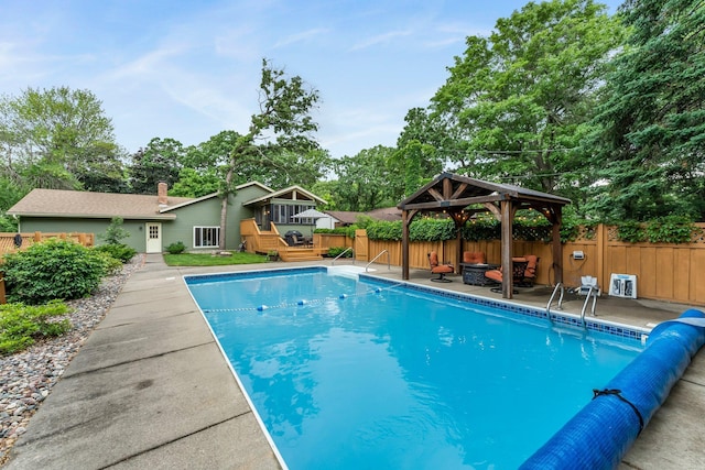 8409 Knollwood Dr, Mounds View, MN 55112 - view of swimming pool featuring a gazebo, a deck, and view of wooded area
