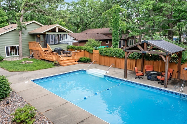 8409 Knollwood Dr, Mounds View, MN 55112 - view of swimming pool featuring a fire pit, a deck, a gazebo, a fenced backyard, and grilling area
