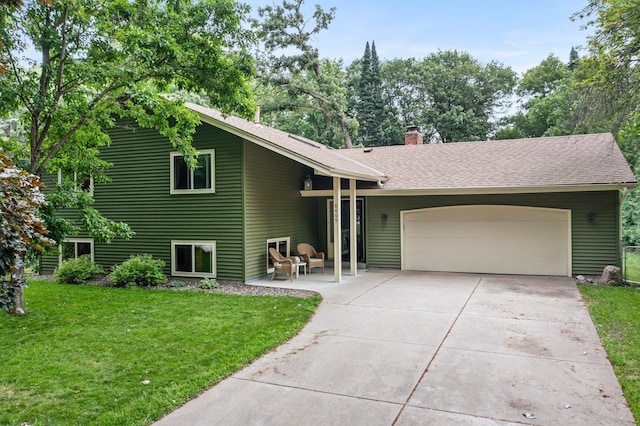 8409 Knollwood Dr, Mounds View, MN 55112 - view of front of home featuring a garage, a front yard, a chimney, driveway, and a shingled roof