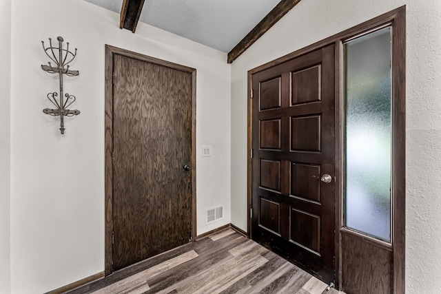 8409 Knollwood Dr, Mounds View, MN 55112 - entryway featuring wood finished floors, beamed ceiling, a textured ceiling, and baseboards