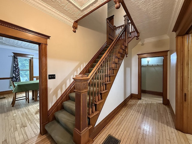78994 160th St, Sacred Heart, MN 56285 - stairway featuring hardwood / wood-style flooring, crown molding, and baseboards