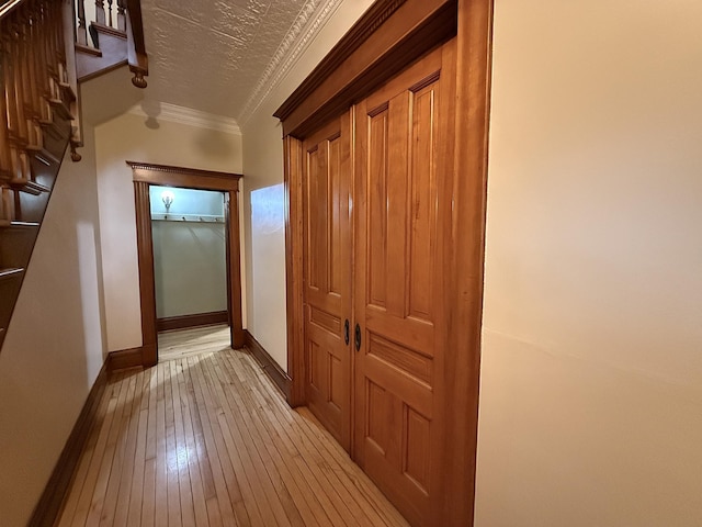 78994 160th St, Sacred Heart, MN 56285 - corridor featuring light wood-style flooring, crown molding, baseboards, and stairs