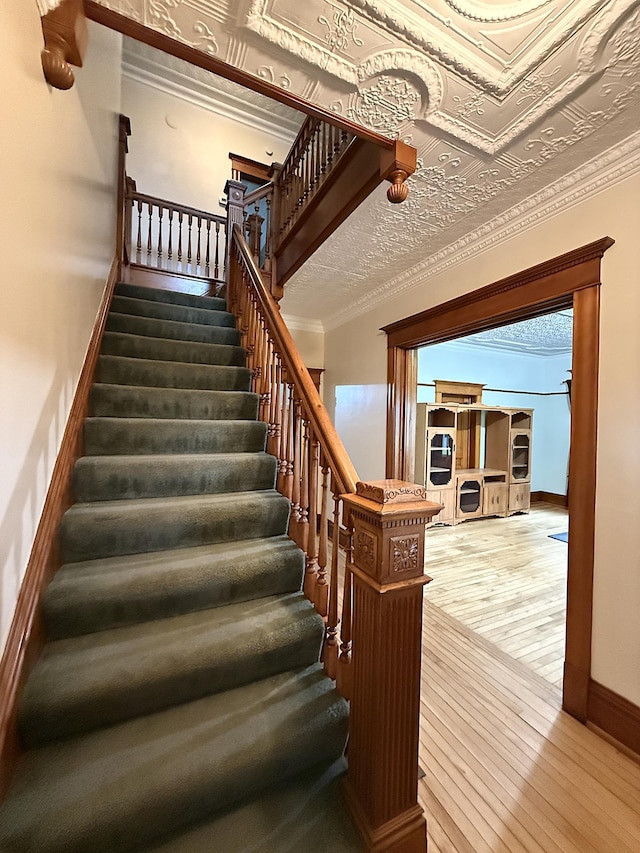 78994 160th St, Sacred Heart, MN 56285 - stairs featuring hardwood / wood-style floors, baseboards, and crown molding