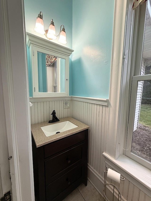 78994 160th St, Sacred Heart, MN 56285 - bathroom with vanity, wainscoting, tile patterned floors, and radiator