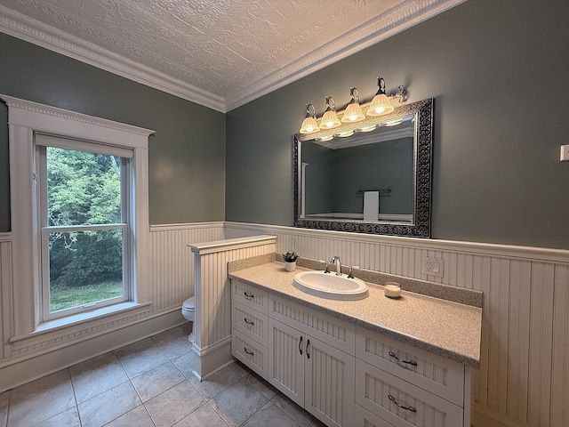 78994 160th St, Sacred Heart, MN 56285 - bathroom with toilet, vanity, a wainscoted wall, crown molding, and tile patterned flooring