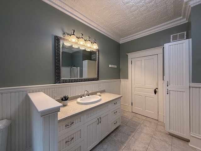 78994 160th St, Sacred Heart, MN 56285 - bathroom with vanity, wainscoting, tile patterned flooring, ornamental molding, and toilet