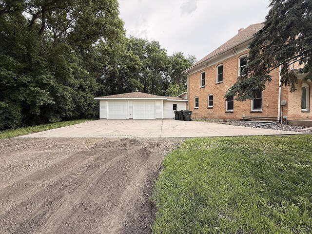 78994 160th St, Sacred Heart, MN 56285 - view of front of house with an outbuilding, a garage, brick siding, and a front lawn