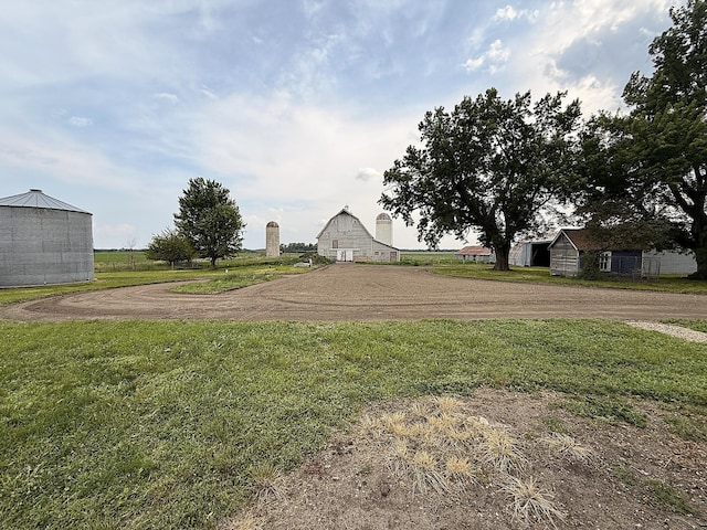 78994 160th St, Sacred Heart, MN 56285 - view of green lawn with a barn, an outbuilding, and dirt driveway