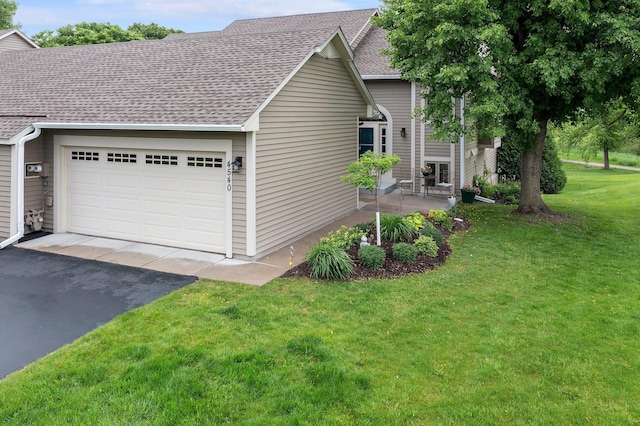 4540 Niagara Ln N, Plymouth, MN 55446 - view of side of property featuring roof with shingles, an attached garage, driveway, and a lawn