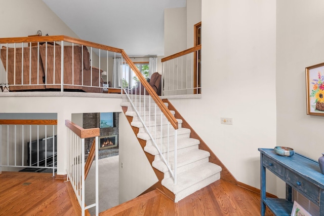 4540 Niagara Ln N, Plymouth, MN 55446 - stairs featuring wood finished floors and a warm lit fireplace
