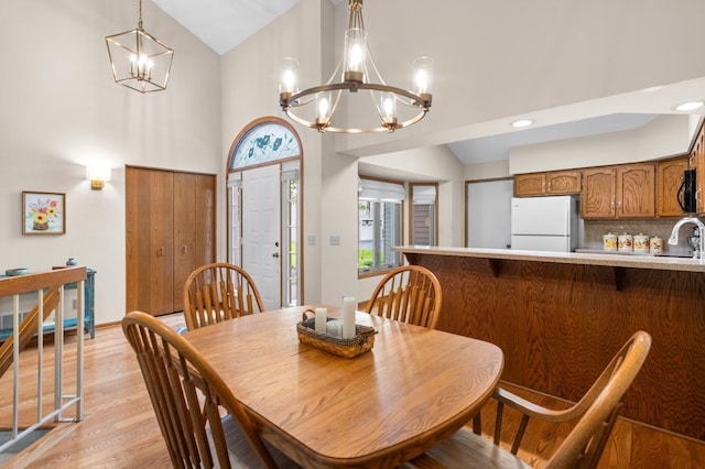 4540 Niagara Ln N, Plymouth, MN 55446 - dining room with a chandelier, light wood-style flooring, and high vaulted ceiling