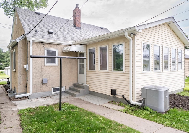 1368 Dale St N, Saint Paul, MN 55117 - back of property featuring entry steps, roof with shingles, and a chimney
