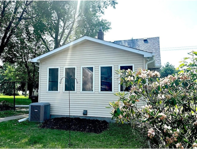 1368 Dale St N, Saint Paul, MN 55117 - view of side of property with a central air condition unit and a chimney