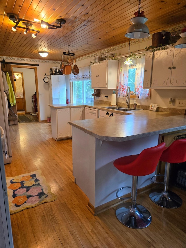 44416 Georgia Ave, Harris, MN 55032 - kitchen featuring a peninsula, wood ceiling, white cabinets, and healthy amount of natural light