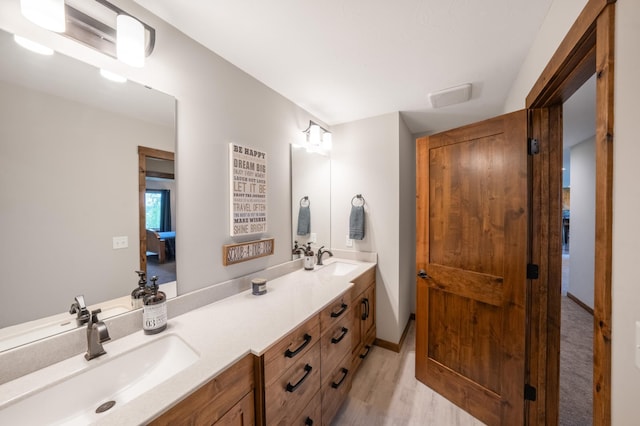29437 141st Ave, Lanesburgh Twp, MN 56071 - bathroom with double vanity, wood finished floors, and baseboards