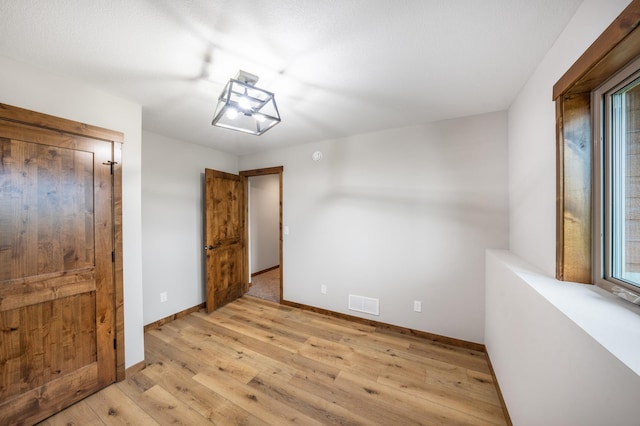 29437 141st Ave, Lanesburgh Twp, MN 56071 - unfurnished bedroom with light wood-type flooring and baseboards