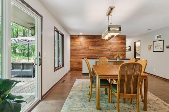 303 Cove Rd, Troy Twp, WI 54016 - dining area featuring wood walls, dark wood-type flooring, baseboards, and recessed lighting