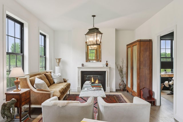2176 153rd Ave, Mora, MN 55051 - living area featuring plenty of natural light, wood finished floors, and a chandelier