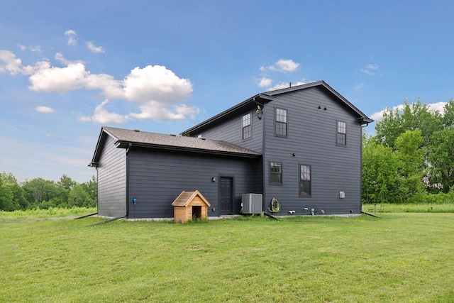 2176 153rd Ave, Mora, MN 55051 - rear view of house featuring a lawn and central air condition unit