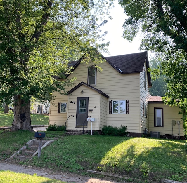 643 Miller Ave, Windom, MN 56101 - bungalow-style house featuring a shingled roof, a front yard, and central AC unit