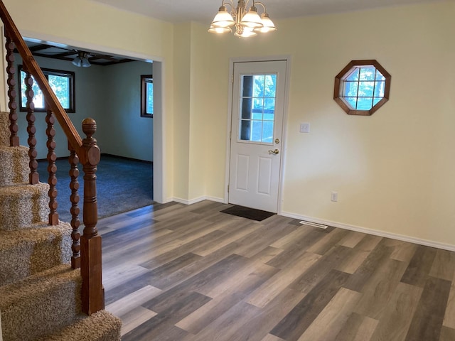 643 Miller Ave, Windom, MN 56101 - foyer entrance with stairs, a chandelier, dark wood-style flooring, and baseboards