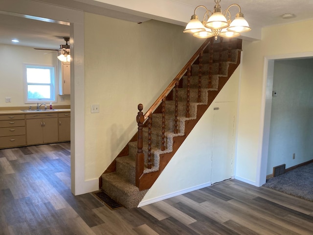 643 Miller Ave, Windom, MN 56101 - stairway featuring wood finished floors, ceiling fan, a chandelier, and baseboards